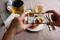 close-up-on-food-lover-taking-pictures-of-meal